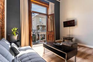 a living room with a couch and a large window at Long Street Boutique Hotel in Cape Town