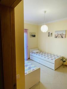 a bedroom with two beds and a window at by blen.d in Albufeira +8 photos
