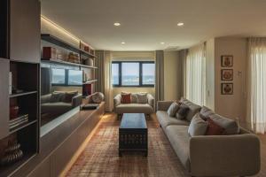 a living room with a couch and a table at Ocean Vista - Premium CityCenter in Ponta Delgada