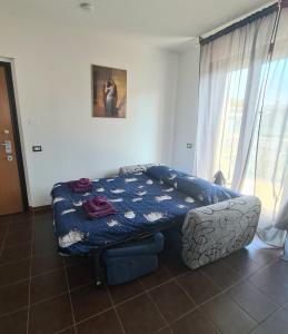 a bedroom with a bed and a couch and a window at Milano Santa Giulia Business Apartment - Olimpiadi 26 in Milan