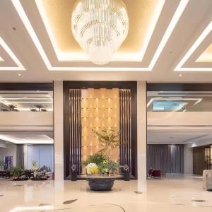 a lobby with a large chandelier in a building at Bosai Hotel Shanghai Hongqiao Railway Station National Convention and Exhibition Center in Shanghai