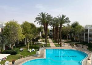a view of a pool at a resort with palm trees at Luxury Queen Royal Park in Eilat