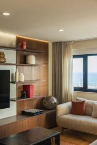 a living room with a couch and a television at Ocean Vista - Premium CityCenter in Ponta Delgada