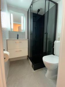 a bathroom with a toilet and a glass shower at Mango Spirit Suites in Neuchâtel