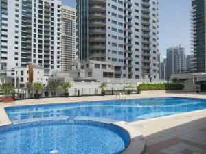 a large swimming pool in a city with tall buildings at Frank Porter - Marina Views Tower in Dubai