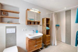 a bathroom with a sink and a shower at Ferienwohnung Birke in Altusried +19 photos