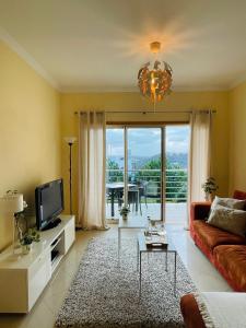 a living room with a couch and a tv at by blen.d in Albufeira