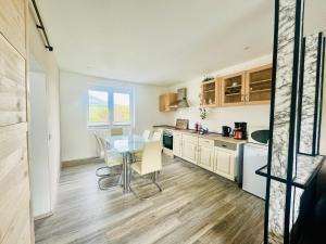 a kitchen with a table and chairs in a room at Sollstedt Paradies 