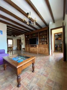 a living room with a table and a tv at El Olivar Lidia in Puerto del Rosario
