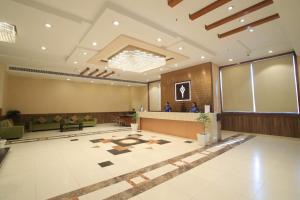 a large lobby with a large screen in the middle at Hotel Adityaz in Gwalior