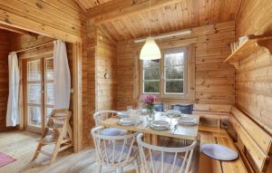 a dining room with a table in a wooden cabin at Ferienhaus Donau 73 in Hayingen