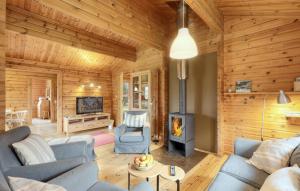 a living room with a fireplace in a log cabin at Ferienhaus Donau 73 in Hayingen