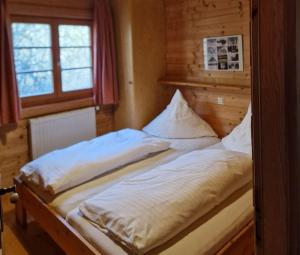 a large bed in a room with a window at Ferienhaus Neckar 34 in Hayingen