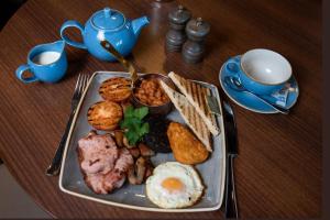 a plate of breakfast food on a wooden table at The Windermere Rooms at The Wateredge Inn, Ambleside in Ambleside +48 photos