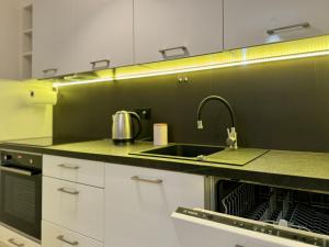 a kitchen with a sink and a stove at K22 Komputerowa 7 Chopin Airport in Warsaw