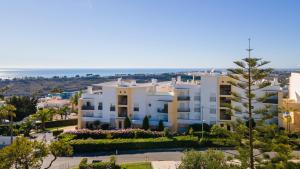 a view of a building with the ocean in the background at by blen.d in Albufeira