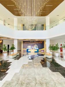 a large lobby with a chandelier in a building at FLC Sea Tower Wins Quy Nhơn in Quy Nhon