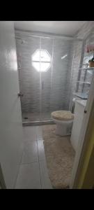 a bathroom with a toilet and a glass door at Shauna apartment in Charlton