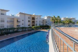 an image of a swimming pool in front of some apartment buildings at by blen.d in Albufeira