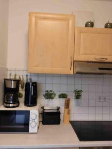 a kitchen counter with a coffee maker and a microwave at Fewo 4 in Gotha