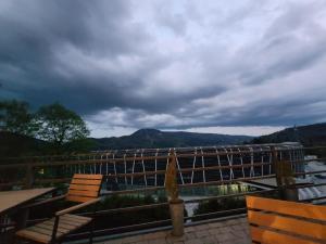 a balcony with chairs and a view of a river at Willa Orle Gniazdo in Szczyrk