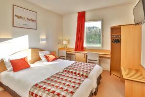 a hotel room with a bed and a desk at ACE Hôtel Vendée Saint Hermine in Sainte-Hermine