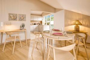 a kitchen and dining room with a table and chairs at Meierhof Appartements in Glücksburg