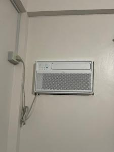a air conditioner is hanging on a wall at Maria kulafu studio 2 in Masbate