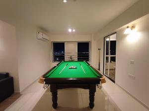 a ping pong table in a room with a pool at Beta Room in Ahmedabad