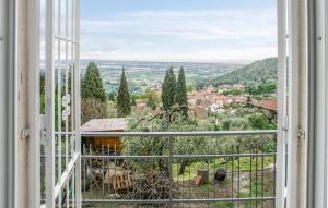 an open window with a view of a city at Gorgeous Apartment In Corsanico With House A Panoramic View in Corsanico-Bargecchia