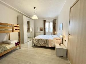 a bedroom with two beds and a bunk bed at Casa Linda in Corsico