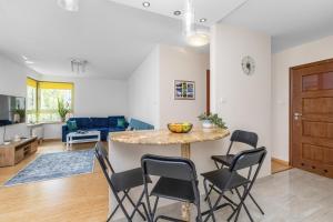 a kitchen and living room with a table and chairs at Seaside Apartment with Parking in Sopot by Renters in Sopot