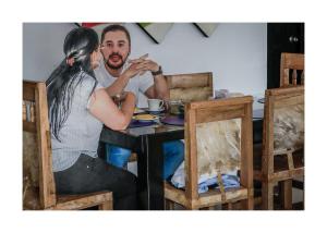 a man and a woman sitting at a table at Hotel Brisas del Nare in Ríohacha