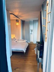 a bedroom with a large bed in a room at Charming Tiny Garden House for two in Lucerne