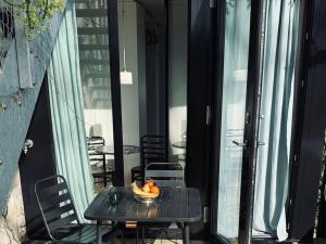 a bowl of fruit sitting on a table on a balcony at Charming Tiny Garden House for two in Lucerne