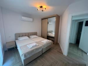 a small bedroom with a bed and a mirror at No 444 in Dalaman