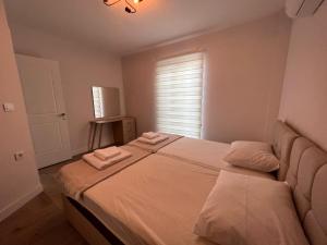 a bedroom with a large bed with two towels on it at incebel No 444 in Dalaman