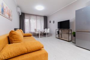un salon avec un canapé et une télévision à écran plat dans l'établissement Cozy 2-bed Apartment, à Plovdiv