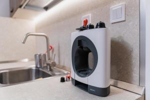 une cafetière posée sur un comptoir à côté d'un évier dans l'établissement Cozy 2-bed Apartment, à Plovdiv 31 autres photos