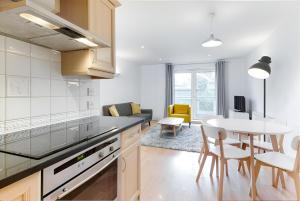 a kitchen and living room with a table and chairs at Clerkenwell Serviced Apartments in London