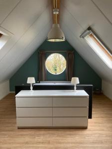 a room with a window in a attic at 't Uilengat 6-8 persoons appartement in Retranchement