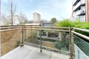 a balcony with glass railings and a brick wall at Clerkenwell Serviced Apartments in London