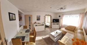 a living room with a couch and a table at Casa Mia 40 am See in Joachimsthal