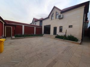a large patio in front of a house at Luxury Forestside Villa in Quba