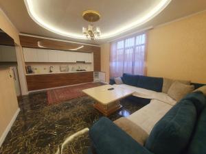 a living room with a couch and a table at Luxury Forestside Villa in Quba +8 photos