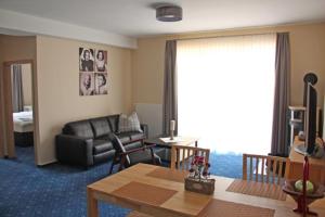 a living room with a couch and a table at Am Apfelbaum 4 Pers in Röbel