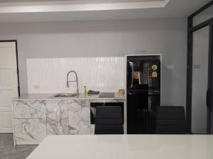 a kitchen with a marble counter top and a sink at View Talay6 by Blue Ocean Suite in Pattaya Central