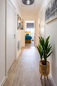 a hallway with a potted plant and a bedroom at Waterside 2Bed Apartment Taunton in Taunton