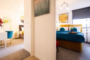 - une chambre avec un lit bleu dans l'établissement Waterside 2Bed Apartment Taunton, à Taunton