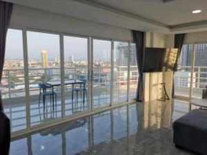 a living room with a view of a city at View Talay6 by Blue Ocean Suite in Pattaya